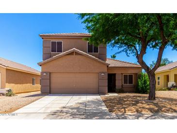Charming two-story home featuring a neutral color scheme, well-maintained landscaping, and a two-car garage in a sunny neighborhood at 15427 W Port Au Prince Ln, Surprise, AZ 85379