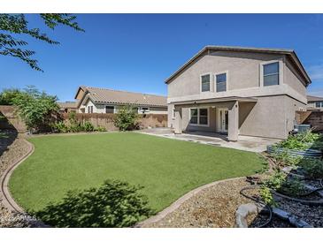 This backyard has an expansive lawn and patio area for relaxing and entertaining at 1839 E Parkside Ln, Phoenix, AZ 85024