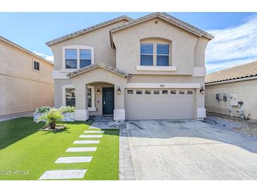 Charming two-story home features manicured lawn, walkway, and two-car garage at 1839 E Parkside Ln, Phoenix, AZ 85024