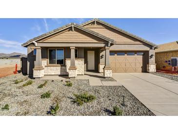 Charming single-story home with stone accents, a two-car garage, and low-maintenance landscaping at 19026 W Stella Ave, Waddell, AZ 85355