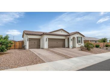 Charming single-story home featuring a two-car garage, desert landscaping, and a tile roof at 19806 W Marshall Ave, Litchfield Park, AZ 85340