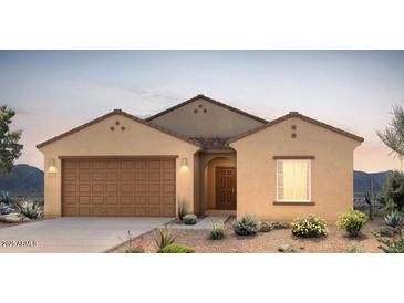 Charming single-story home with a two-car garage, desert landscaping, and stucco exterior at 25138 W Chanute Pass, Buckeye, AZ 85326