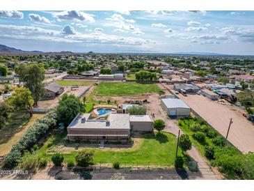 Sprawling property featuring a pool, grassy area, and residential buildings surrounded by the local community at 26232 S Lemon Ave, Queen Creek, AZ 85142
