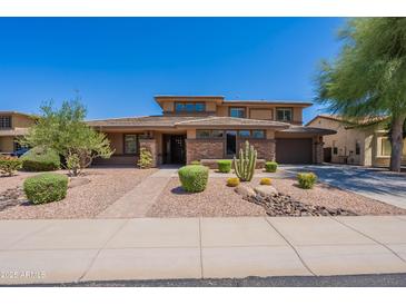 Charming two-story home with well-maintained desert landscaping and brick accents at 30277 N 125Th Ln, Peoria, AZ 85383