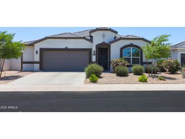 Charming single-story home featuring a two-car garage and beautiful desert landscaping at 37903 W San Clemente St, Maricopa, AZ 85138
