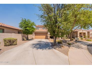 Charming home with a two-car garage and desert landscaping at 7169 S Dodane Ct, Gilbert, AZ 85298
