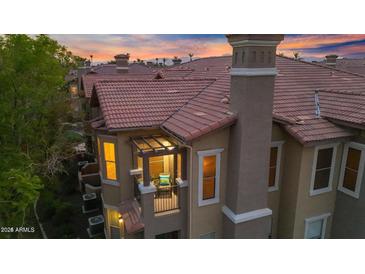 Beautiful two-story condo with balcony, red tile roof and view of colorful sunset at 14250 W Wigwam Blvd # 2722, Litchfield Park, AZ 85340