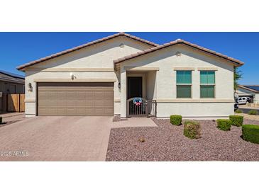 Inviting single-story home featuring a neutral color palette and a well-manicured front yard at 17506 W Hadley St, Goodyear, AZ 85338