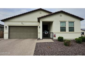 Charming single-story home with desert landscaping, a two-car garage, and a welcoming front porch at 17506 W Hadley St, Goodyear, AZ 85338