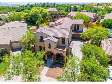Beautiful two-story home featuring a tiled roof, a charming front porch, and a well-maintained landscape at 20639 W Grandview Dr, Buckeye, AZ 85396
