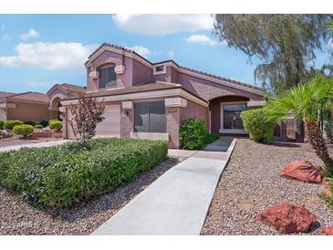 Charming two-story home with a well-manicured lawn and walkway to the entrance at 2114 E Escuda Rd, Phoenix, AZ 85024