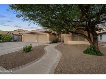 Charming home with a well-manicured front yard, three-car garage and lovely walkway leading to the front door at 2434 S Colleen Sw --, Mesa, AZ 85210