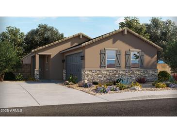 Beautiful single-story home featuring stone accents, neutral-colored exterior, desert landscaping, and an attached two-car garage at 316 S San Christo Ln, Casa Grande, AZ 85194