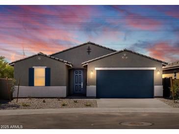 Charming single-story home with a well-manicured front yard and a two-car garage at 37357 W San Sisto Ave, Maricopa, AZ 85138
