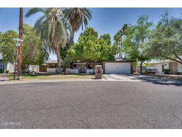 Charming single-story home featuring mature trees, a two-car garage, and a well-maintained front yard at 5307 N 32Nd Pl, Phoenix, AZ 85018