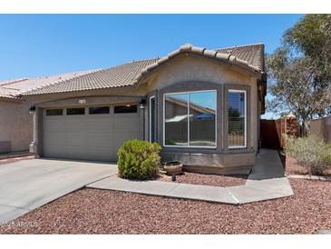 Charming single-story home featuring a tiled roof, a two-car garage, and desert landscaping at 6610 E University Dr # 165, Mesa, AZ 85205