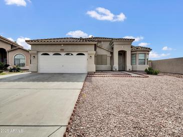 Charming single-story home with a desert-style front yard and a spacious two-car garage at 6752 W Citrus Way, Glendale, AZ 85303