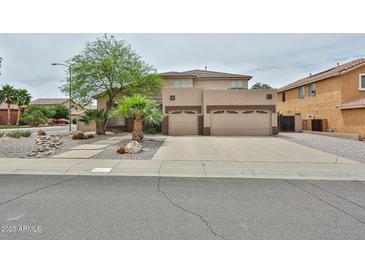 Two-story home featuring a three-car garage and desert landscaping at 6833 W Tether Trl, Peoria, AZ 85383
