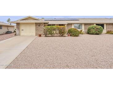 Charming brick home featuring a low-maintenance gravel yard and solar panels at 9814 W Long Hills Dr, Sun City, AZ 85351