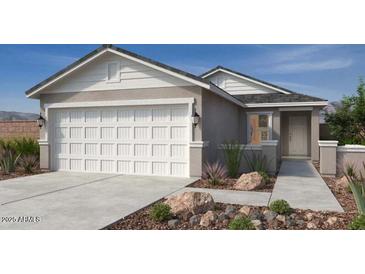 Charming single-Gathering home with a spacious two-car garage and a well-manicured front yard at 18585 N Foxtail Dr, Maricopa, AZ 85138