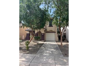 Inviting two-story home featuring a well-manicured lawn and a private two-car garage at 6339 W Sophie Ln, Laveen, AZ 85339