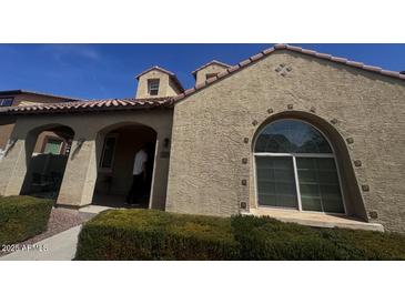 Charming single-Gathering home with stucco exterior, red tile roof, arched window, and covered front porch at 1158 S Lydia Ln, Gilbert, AZ 85296