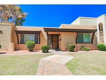 Charming single story home featuring a well-manicured lawn and inviting front walkway at 1726 W Claremont St, Phoenix, AZ 85015