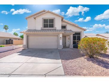 Charming two-story home with a two-car garage, well-maintained landscaping, and beautiful blue sky at 1741 S Clearview Ave # 74, Mesa, AZ 85209