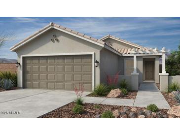 Charming single-Gathering home with a two-car garage, landscaped front yard, and inviting front porch at 18540 N Foxtail Dr, Maricopa, AZ 85138
