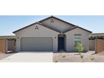Charming single-story home with a two-car garage and low-maintenance desert landscaping at 5840 W Willow Ridge Dr, Laveen, AZ 85339