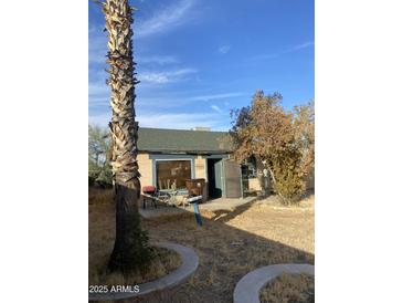 Charming home with a green roof and a cozy patio area for outdoor relaxation at 8022 E 1St Ave, Mesa, AZ 85208