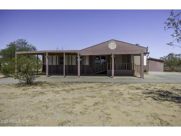 Charming single-story home with covered porch in a rural setting at 10622 N Malachite Way, Casa Grande, AZ 85122