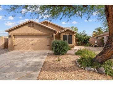 Charming single-story home featuring a two-car garage and desert landscaping for low maintenance at 11405 W Windsor Ave, Avondale, AZ 85392