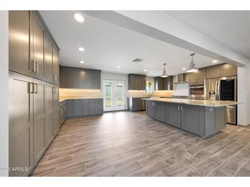 Spacious kitchen features custom gray cabinets, stainless steel appliances, and a large island at 1320 E Butler Dr, Phoenix, AZ 85020
