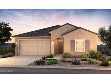 Charming single-story home featuring a two-car garage, neutral stucco finish, and professionally landscaped front yard at 17727 W Pueblo Ave, Goodyear, AZ 85338