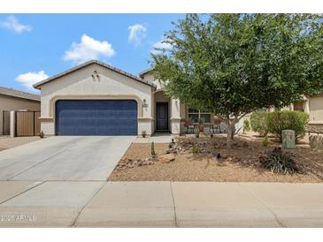 Inviting single-story home featuring a desert landscape, a blue garage door, and a covered porch at 18366 N Arbor Dr, Maricopa, AZ 85138