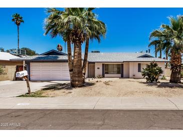 Charming single-story home with a two-car garage and desert landscaping at 4702 W Northview Ave, Glendale, AZ 85301