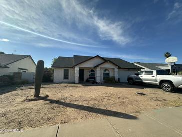 Charming single-story home featuring desert landscaping and a covered entryway at 4928 E Princess Dr, Mesa, AZ 85205