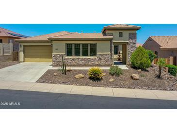 Charming single-story home with desert landscaping, stone accents and a covered entryway at 6914 W Juana Dr, Peoria, AZ 85383