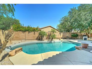 Refreshing backyard pool area with stone accents at 7815 S 22Nd Ln, Phoenix, AZ 85041