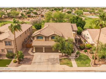 Two-story home featuring a tile roof, a manicured lawn, desert landscaping, and a two-car garage at 9708 E Pampa Ave, Mesa, AZ 85212