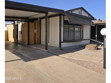 Cozy home featuring a carport, walkway, and low maintenance desert landscaping at 10951 N 91St Ave # 255, Peoria, AZ 85345