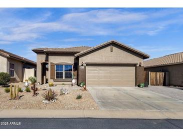Charming single-story home featuring desert landscaping, a two-car garage and neutral exterior paint at 18434 E El Buho Pequeno Rd, Gold Canyon, AZ 85118