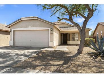 Charming single-story home featuring a two car garage and mature landscaping at 30100 N Sunray Dr, San Tan Valley, AZ 85143