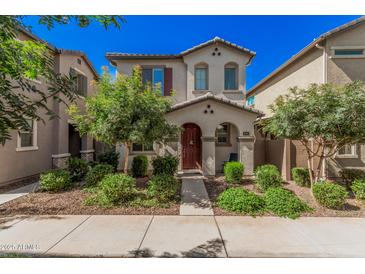 Charming two-story home with a well-manicured front yard and a welcoming red door at 4044 S 58Th Ln, Phoenix, AZ 85043