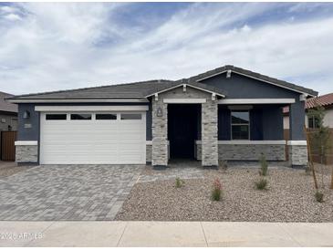 Charming single-story home featuring a two car garage and low maintenance desert landscaping at 40512 W Rio Grande Dr, Maricopa, AZ 85138