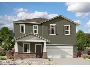Charming two-story home with a covered porch and desert landscaping at 5826 W Sunrise Dr, Laveen, AZ 85339