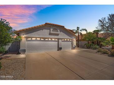 Well-maintained home with a spacious three-car garage and a lovely desert landscape at 7464 E Lompoc Ave, Mesa, AZ 85209