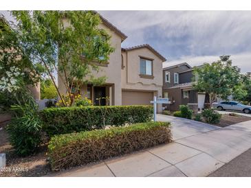 Two-story home featuring manicured landscaping, a two-car garage and sign in the front yard at 8905 W Jefferson St, Tolleson, AZ 85353