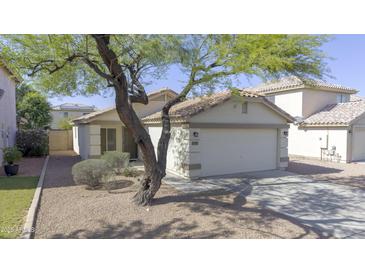Charming single-story home with a well-maintained yard and attached two-car garage at 12046 W Flores Dr, El Mirage, AZ 85335
